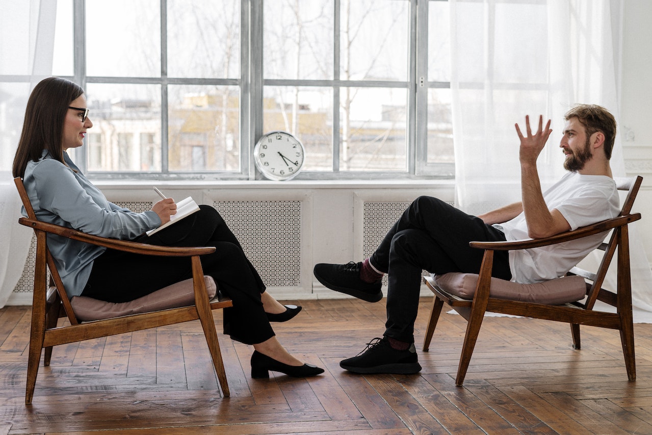 therapist and client sitting in chairs